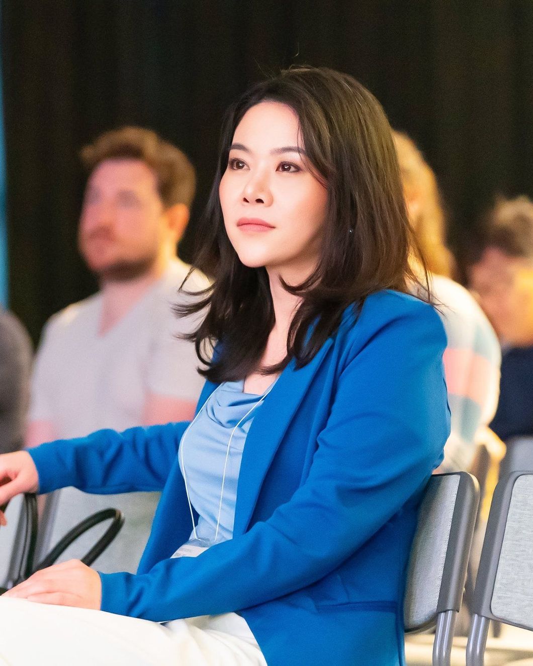 The founder of IGAA seated in the audience at a conference